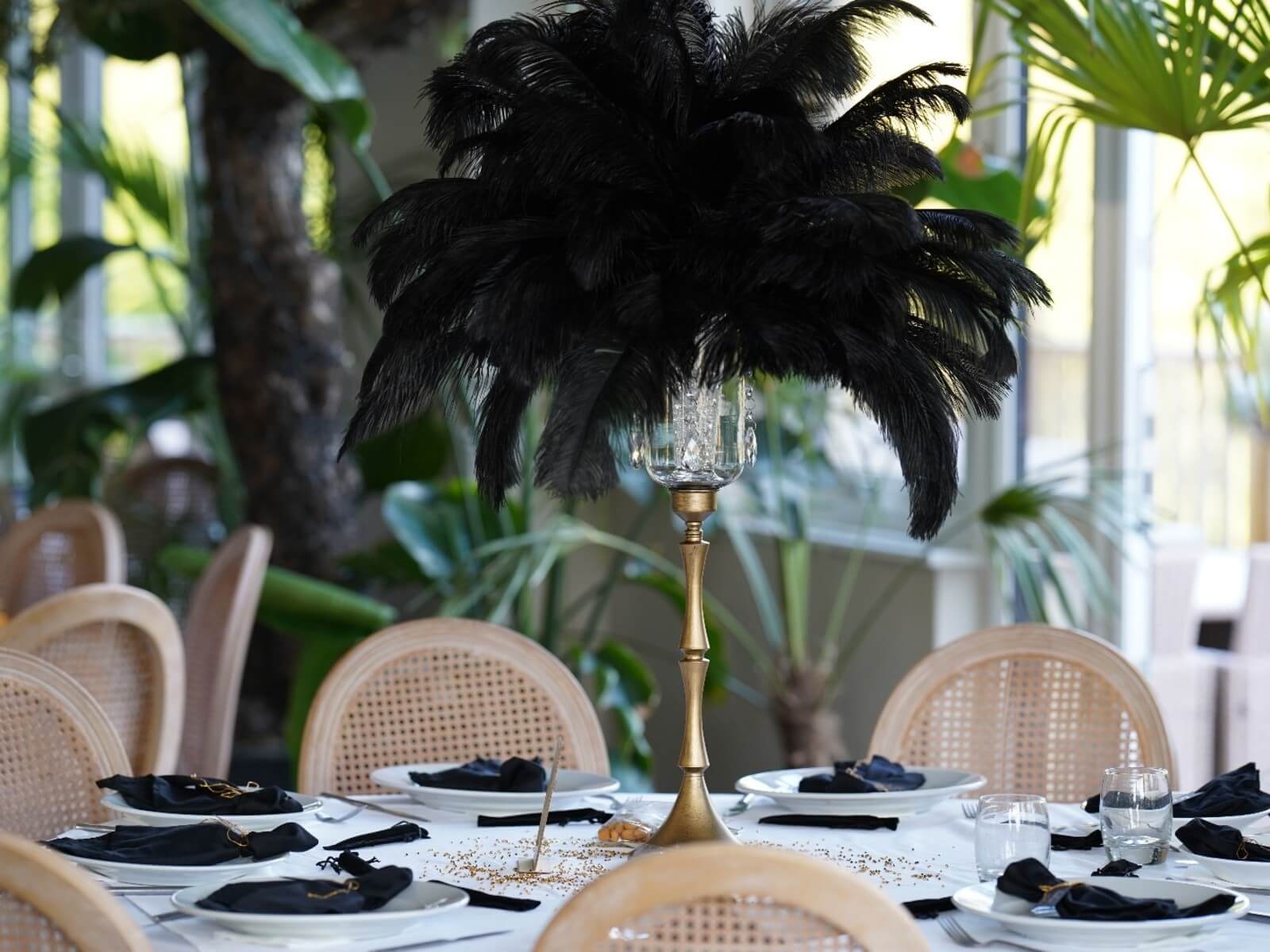 Black ostrich feather centrepiece with a crystal holder on a tall gold stand