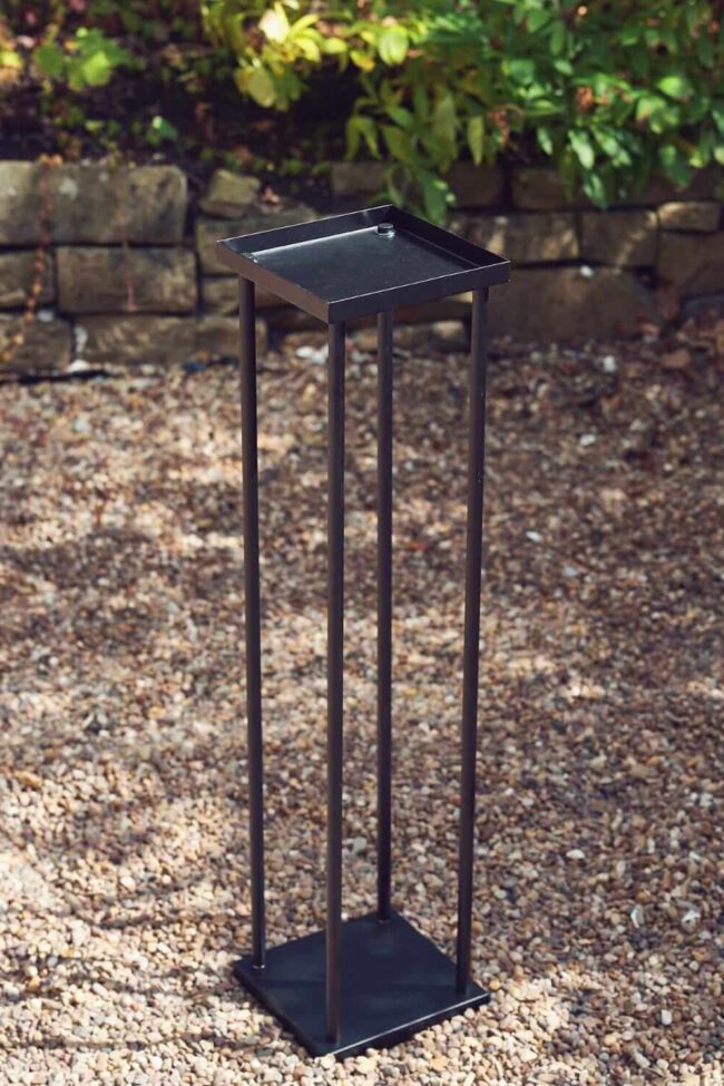 Black metal plinth with an open frame and square base