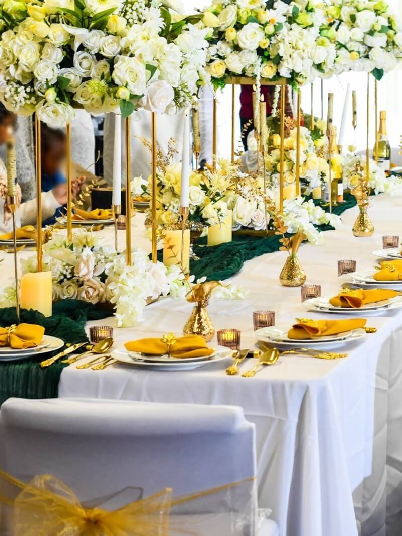 Several 50cm gold plinths arranged along a long table