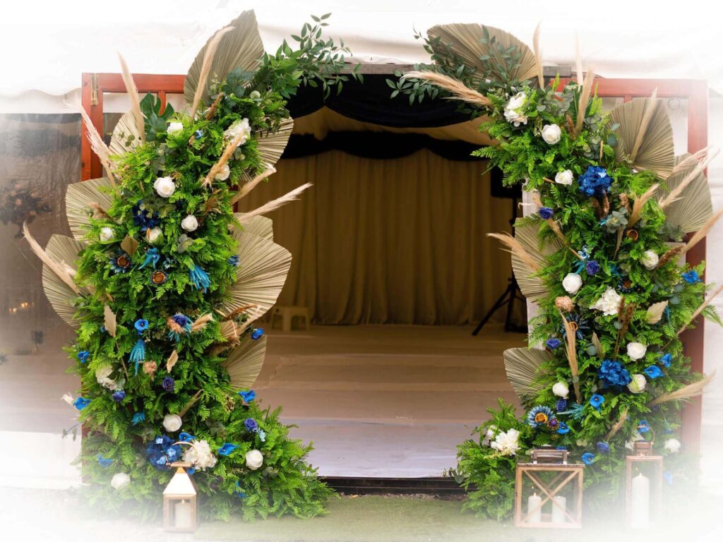 Moongate arch hire with two curved frames styled in blue and white flowers