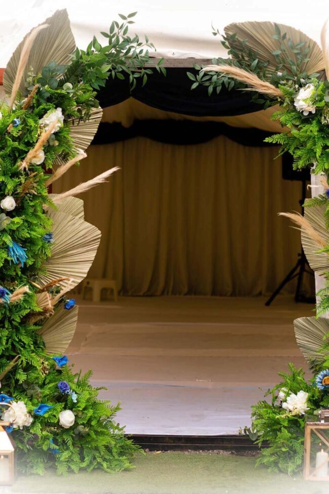 Moongate arch hire with two curved frames styled in blue and white flowers