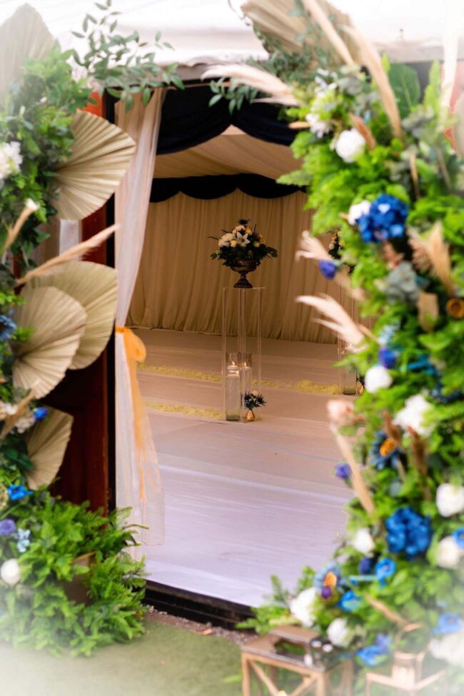 View between two moongate arch frames decorated with blue and white flowers