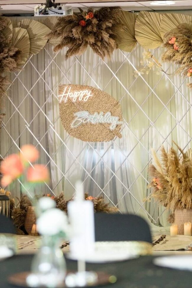 Pampas arch hire with dried palms and orange flowers for a 50th birthday
