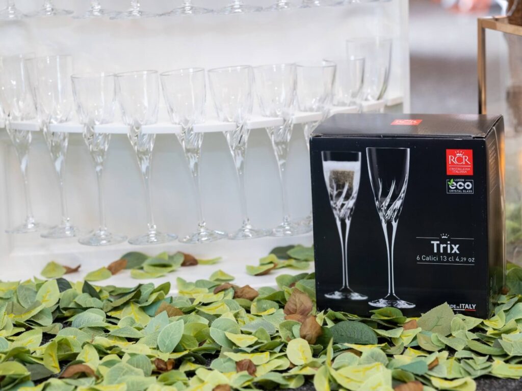 RCR flute glasses displayed on a prosecco cocktail wall by Dream Hire & Deco.