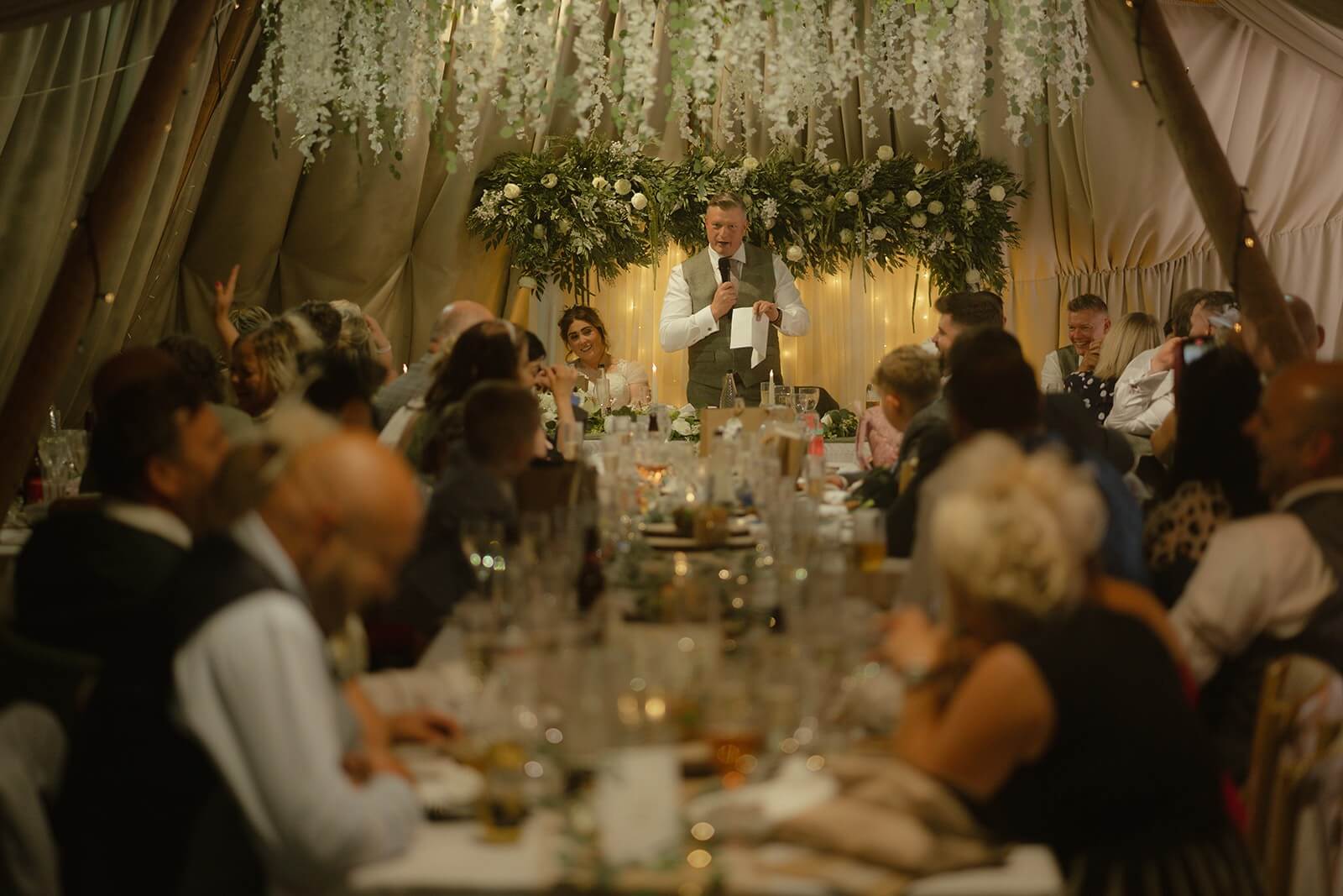 Rustic wedding backdrop with wooden frame and greenery
