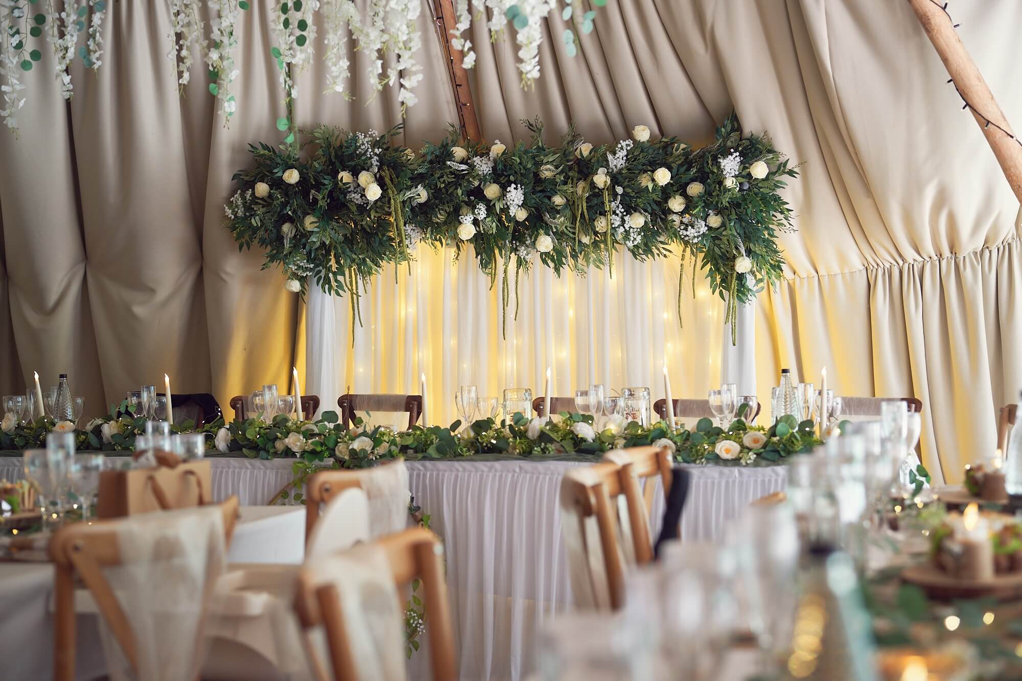 Wedding backdrop rental with layered drapes and LED uplighting