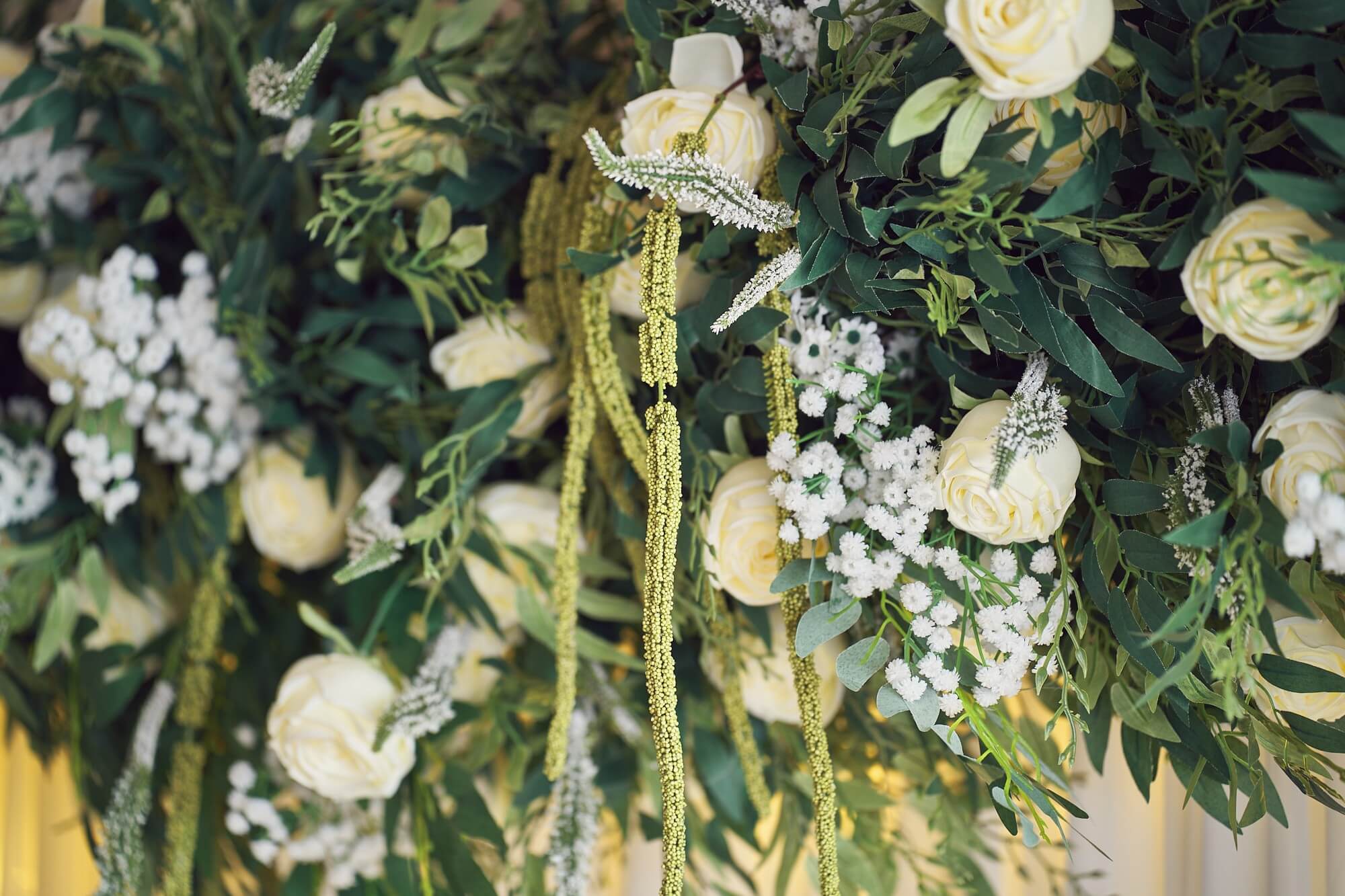 Contemporary wedding backdrop with flower clusters and chiffon fabric