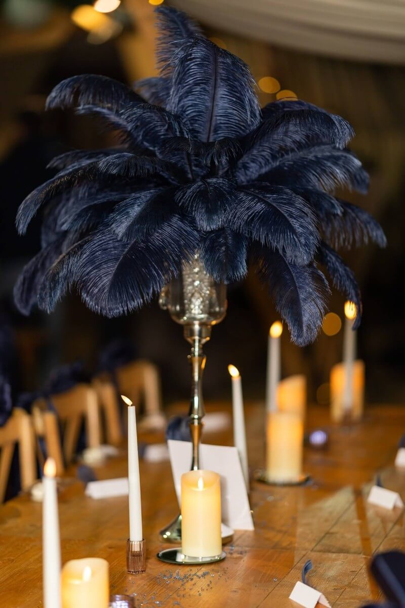 Feather centerpieces displayed on a decorated event table.
