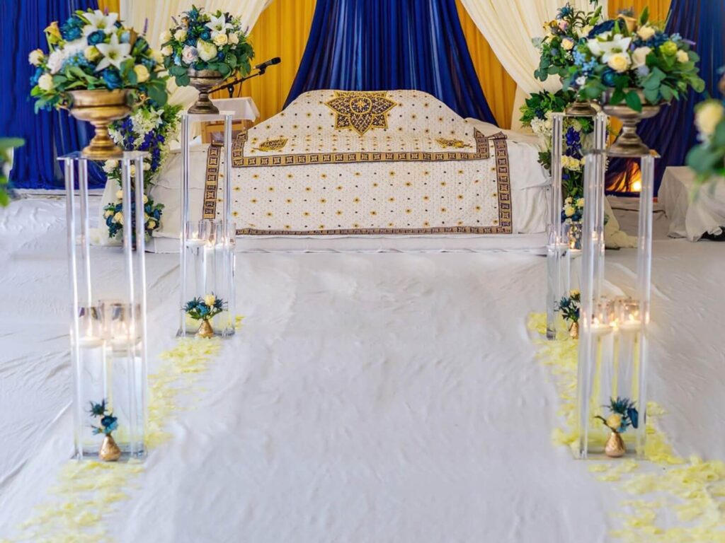 Elegant aisle decor with floral arrangements and candles for event prop hire in Yorkshire.