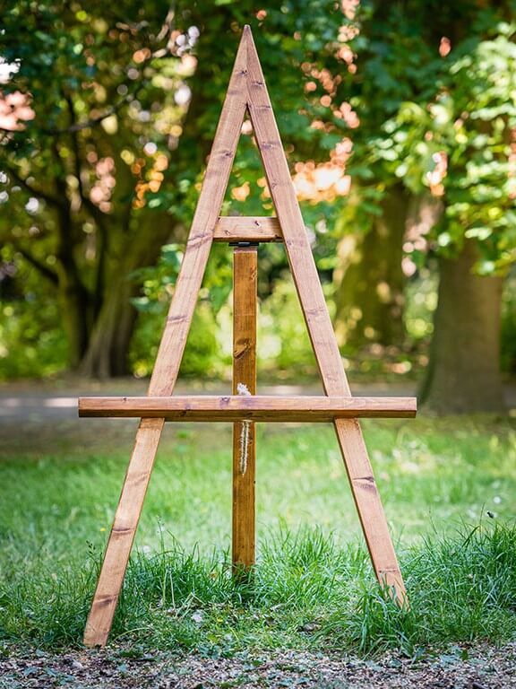 Rustic wooden easel used by wedding decorators near me for signage and event styling.