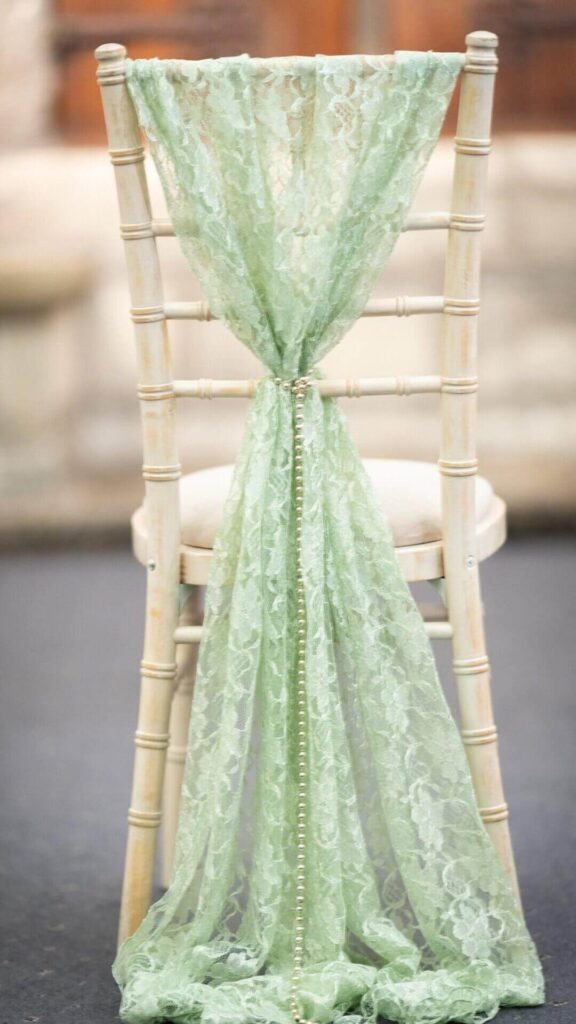 Boho styling sage green lace chair drape with pearl detail for rustic or shabby chic wedding décor.