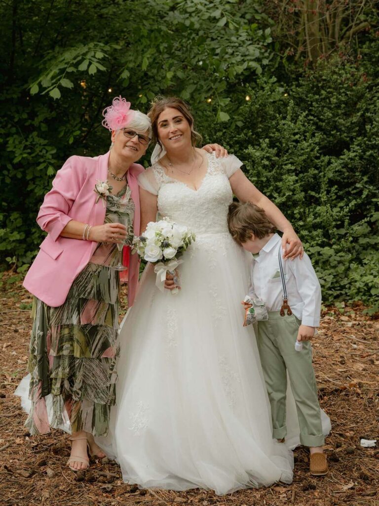 Bride with family outdoors in shabby chic wedding styling.
