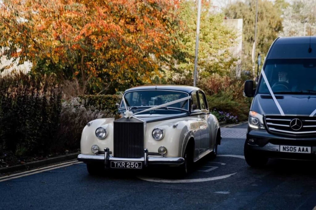 Classic wedding car decorated with ribbon, perfect for a retro wedding theme arrival.
