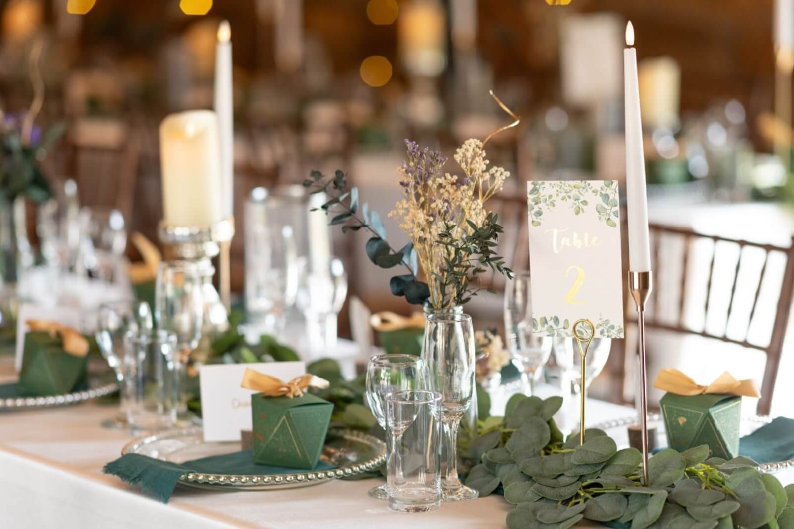 Rustic decorations on tables with candles and eucalyptus