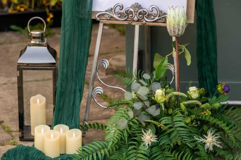 Rustic wedding decor, lantern candles, and greenery
