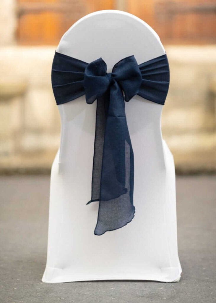 Navy chiffon chair sash bow on a white chair cover