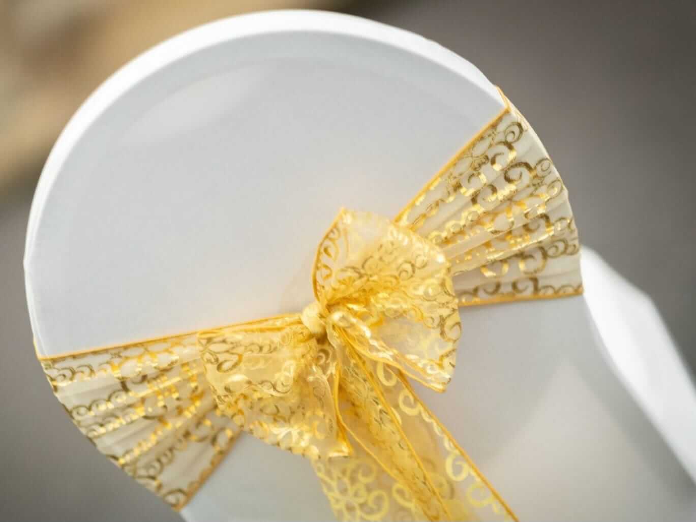 Sash chair covers finished with a patterned sash bow for added texture