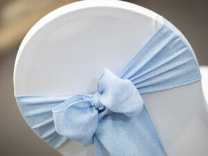 Sash chair covers with a fitted cover and sash bow for a tidy chair back finish