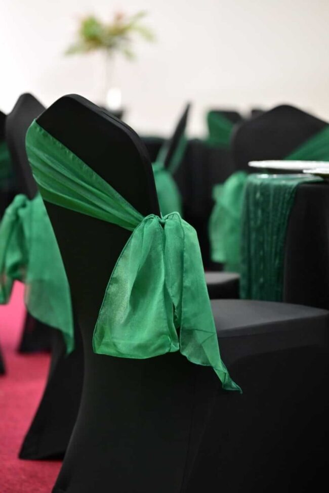 Black chair covers creating a uniform seating setup across a venue room