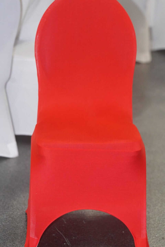 Red chair covers styled on venue chairs for an event setup