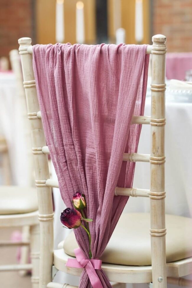wedding breakfast tables with blush chair drapes and styling details