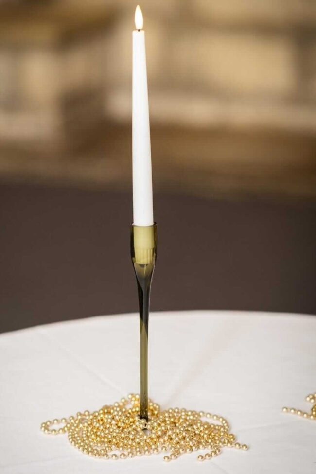 Black taper candle holders styled with dinner candles for modern candlelight