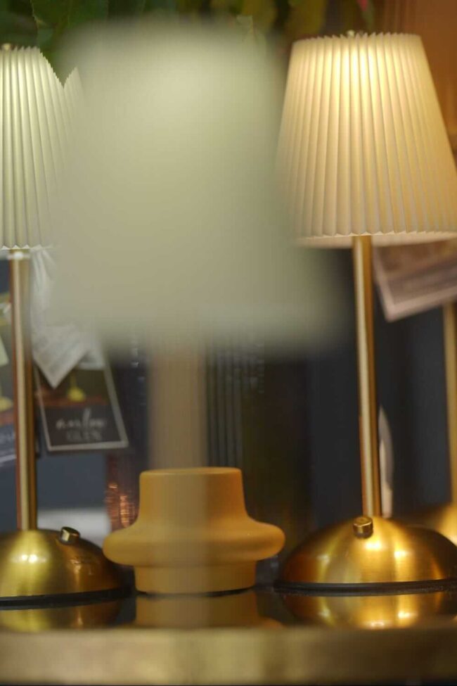 Rechargeable lamp shown as a cordless table lamp with warm glow for events