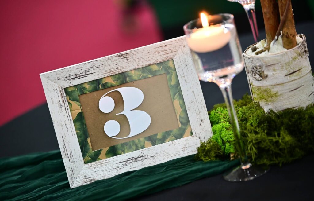 table number frame with candlelight on green table runner