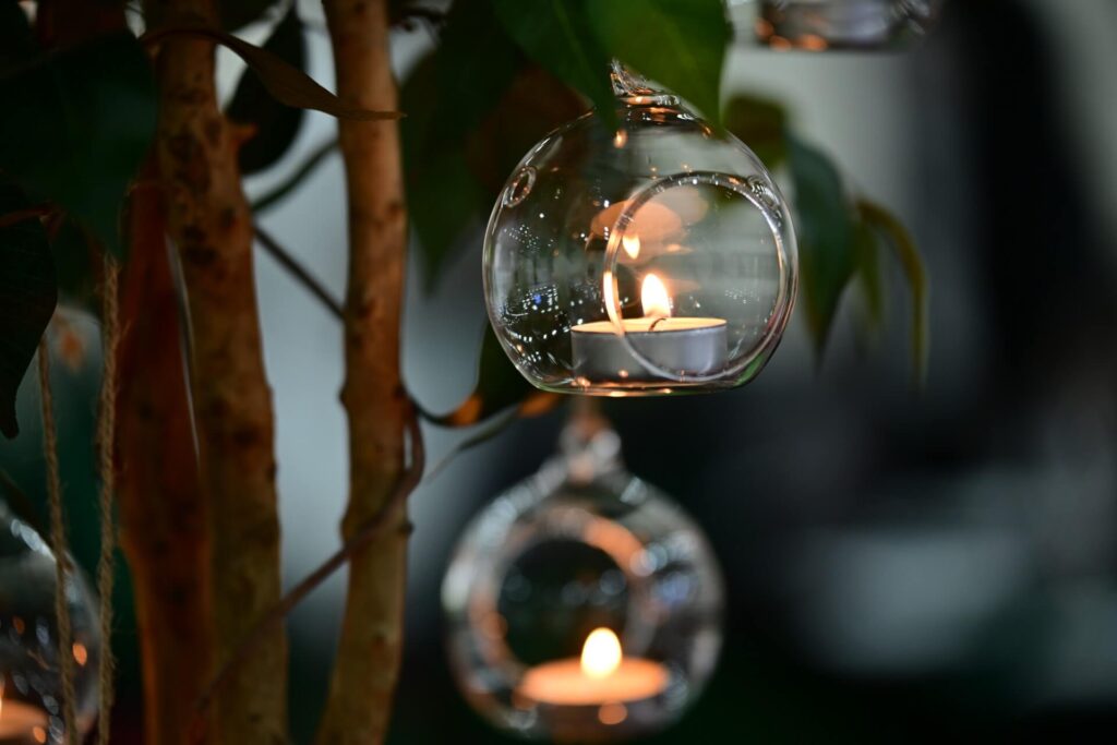 hanging glass tealight candle creating warm glow on tablescape