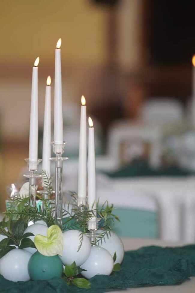 Balloons with flowers, table centrepiece with taper candles and greenery