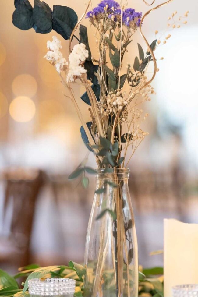 Dried flower centrepieces styled in a glass vase for elegant table decor