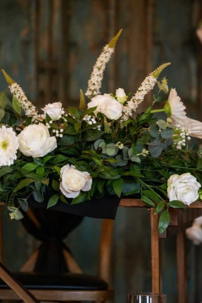 Top table artificial flowers styled as a bespoke front table arrangement