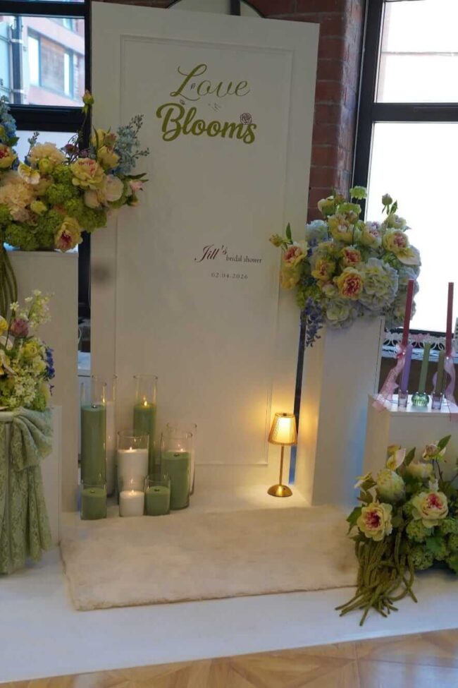 Bridal shower design with personalised sign board, floral plinths and candles