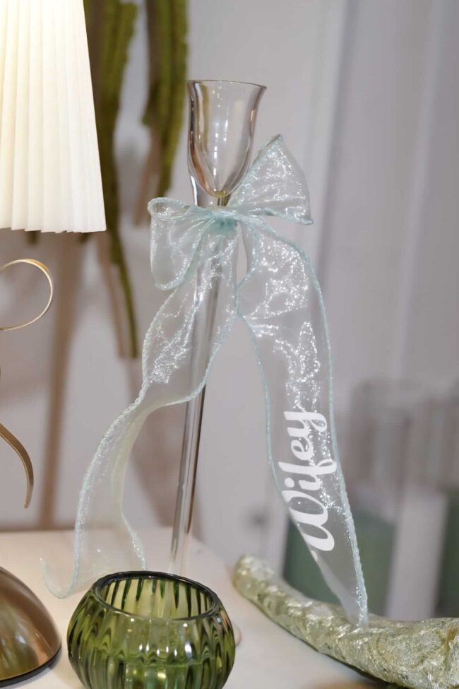 Place cards for wedding tables with a personalised ribbon name styled on glass table décor