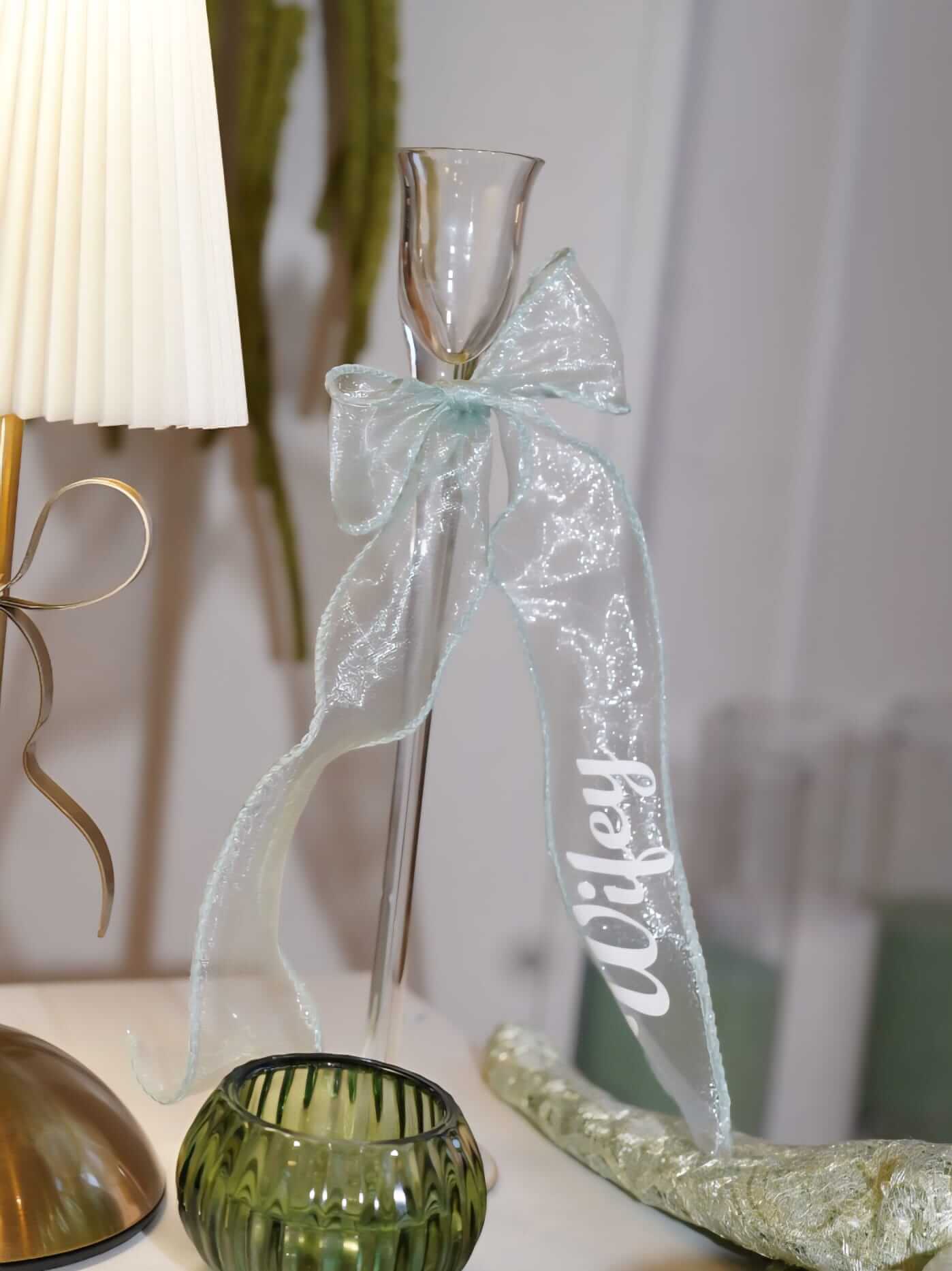 Place cards for wedding tables with a personalised ribbon name styled on glass table décor