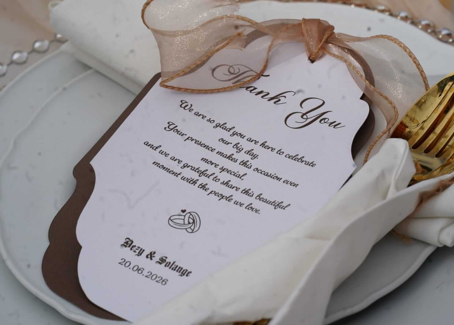 rinted stationery thank you card with ribbon styled on a wedding place setting