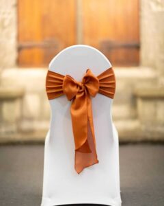 Chair styling idea with a burnt orange sash bow