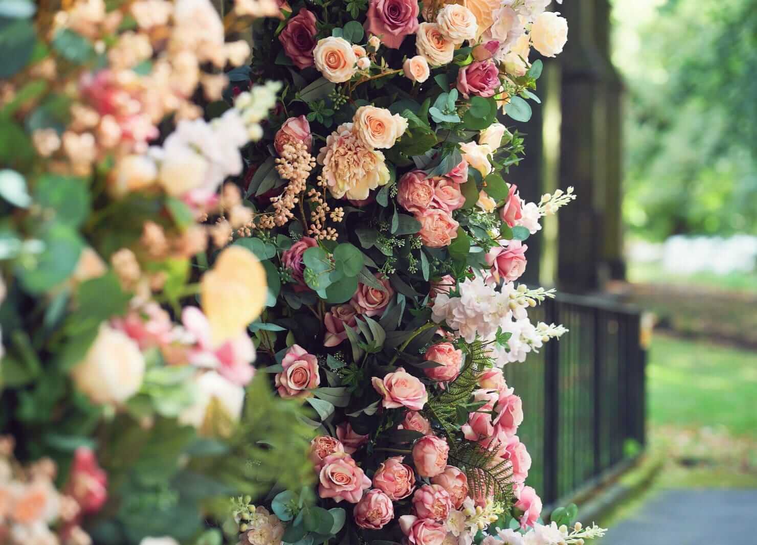 Broken floral arch hire with two staggered pillars of pink and white flowers