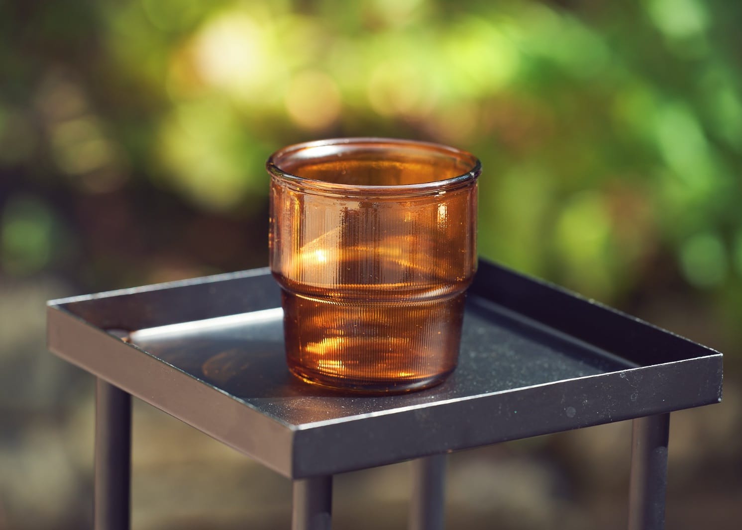 Amber glass tealight holder with warm brown glass finish